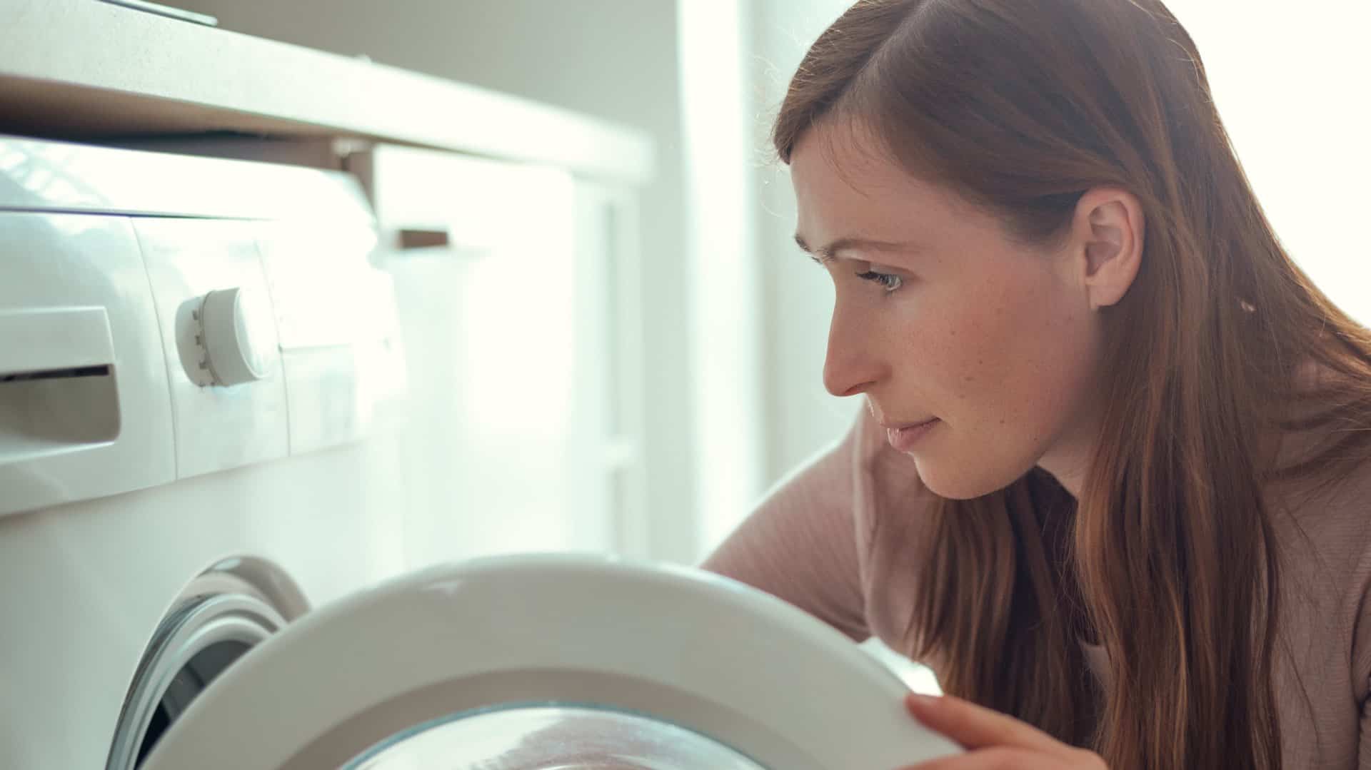 woman looking at washing machine wanting repair in Adelaide
