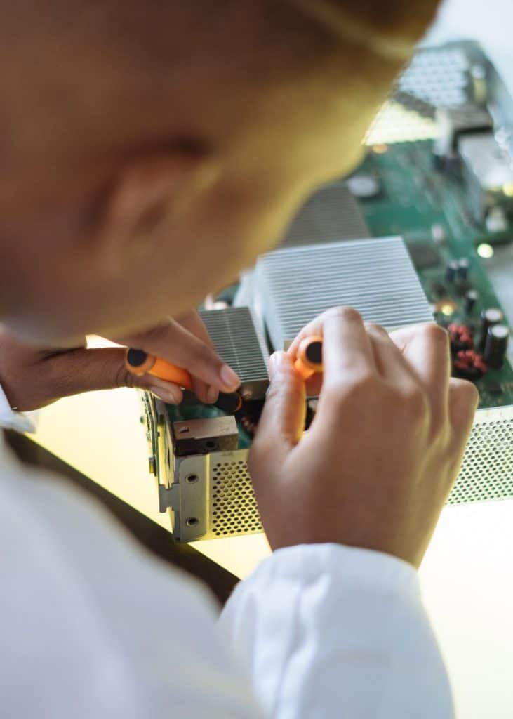 a technician replacing a fuse in board of the oven.