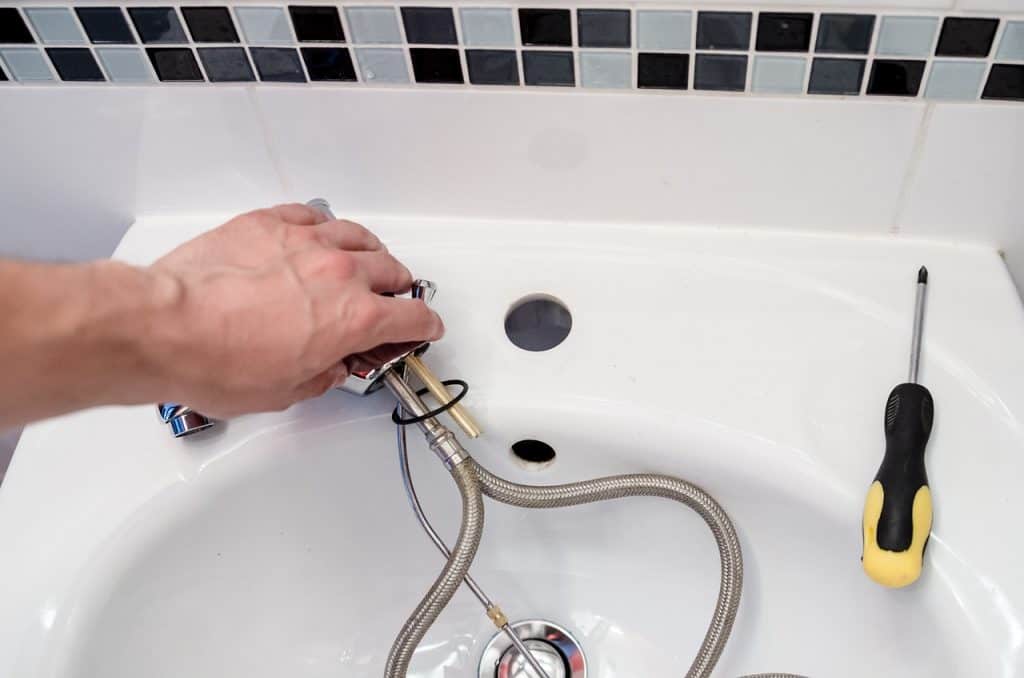 Consider Drain Hose Problems technician repairing a hose with problems