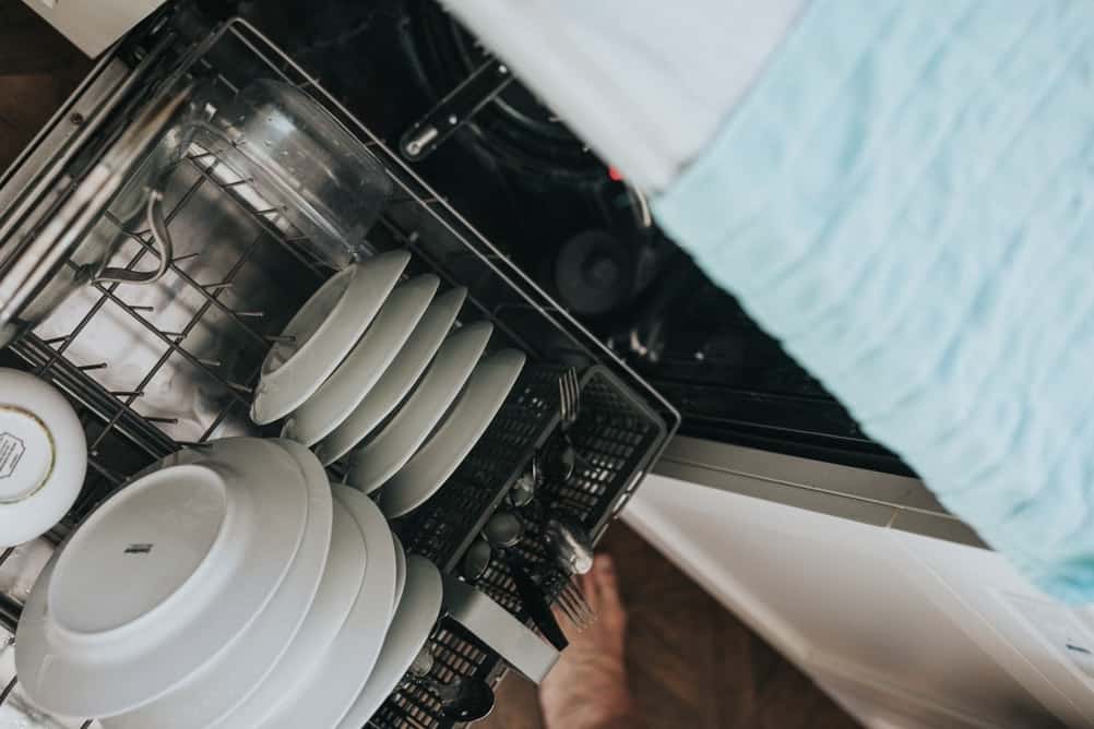 dishwasher with plates, saucer and other kitchen wear.
