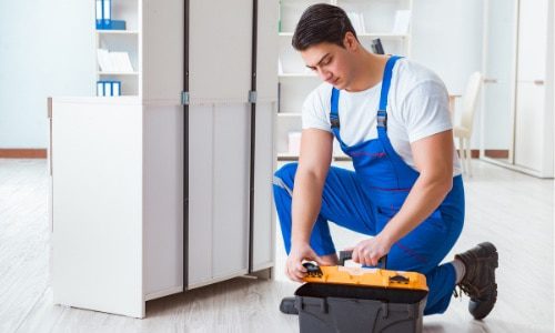 A repairman preparing his tools