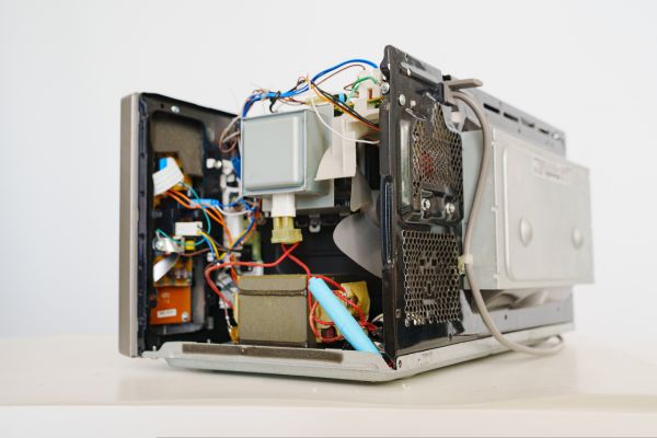 Internal parts of microwave oven being repaired