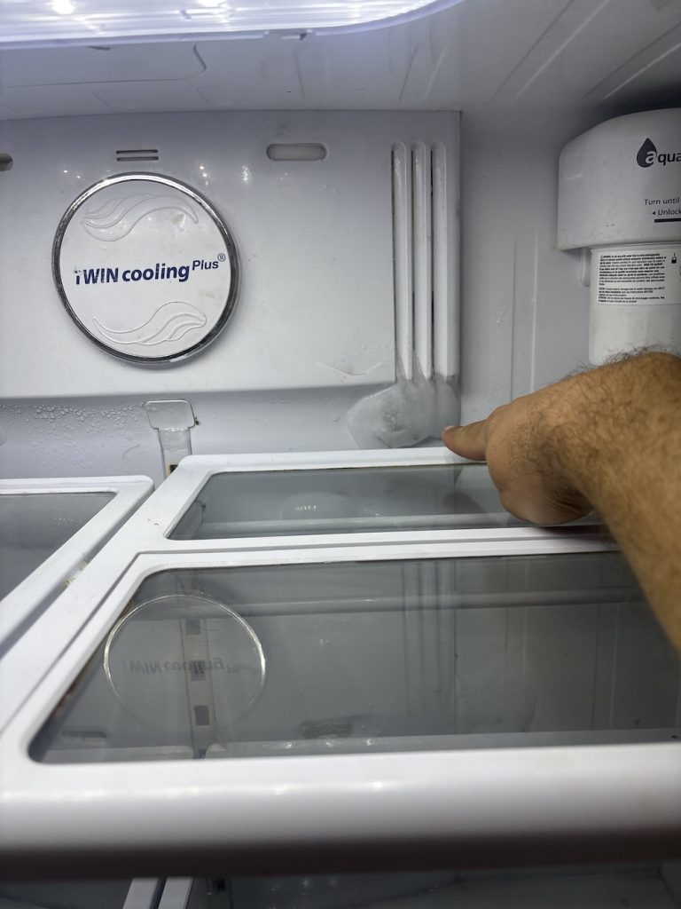 freezer issue freezer repairs technician checking the ice build-up